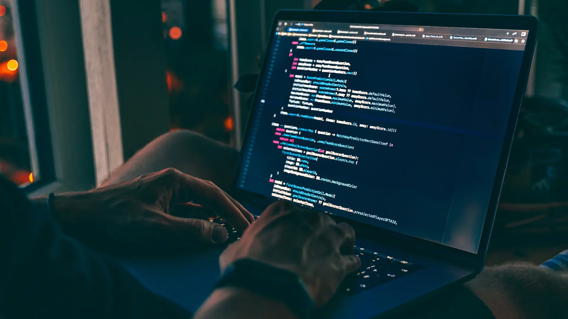 Man doing coding on a laptop